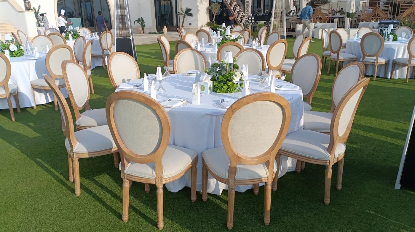 Round tables and Louis chairs on the lawn